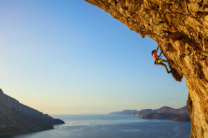 Young woman climbing rockface