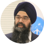 Close-up portrait of a bearded man wearing a black turban and glasses.