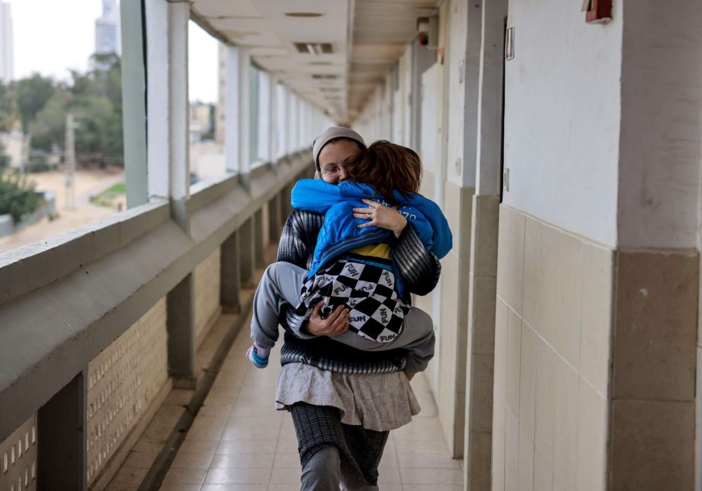 A mother holds her child tight to her chest while running to safety_Credit_GUY YECHIELI (1)_1