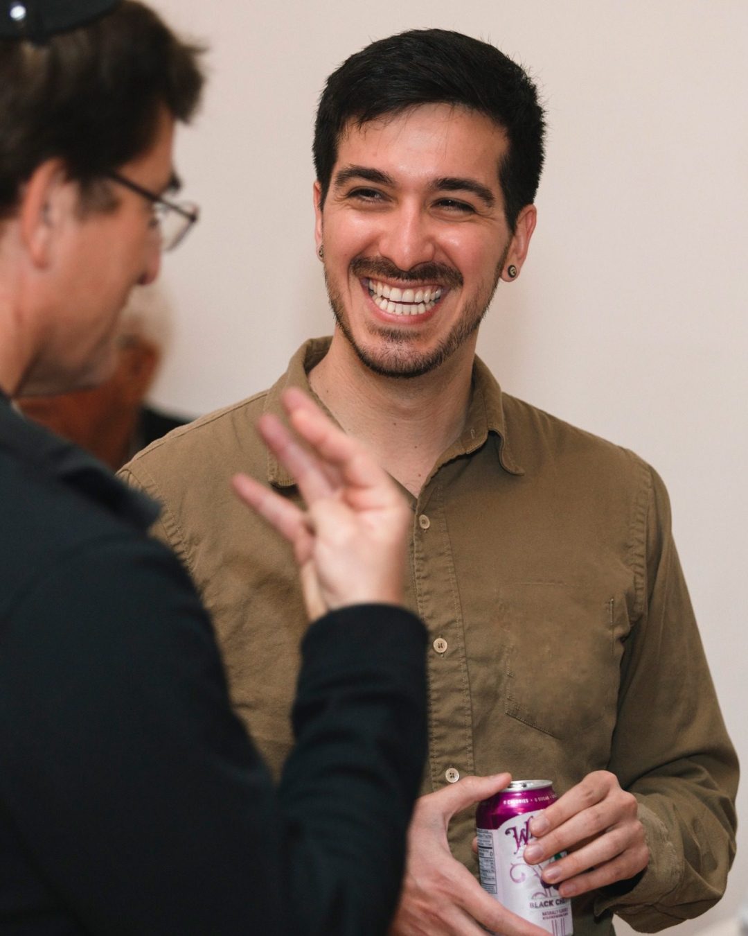 Man Laughing in Conversation