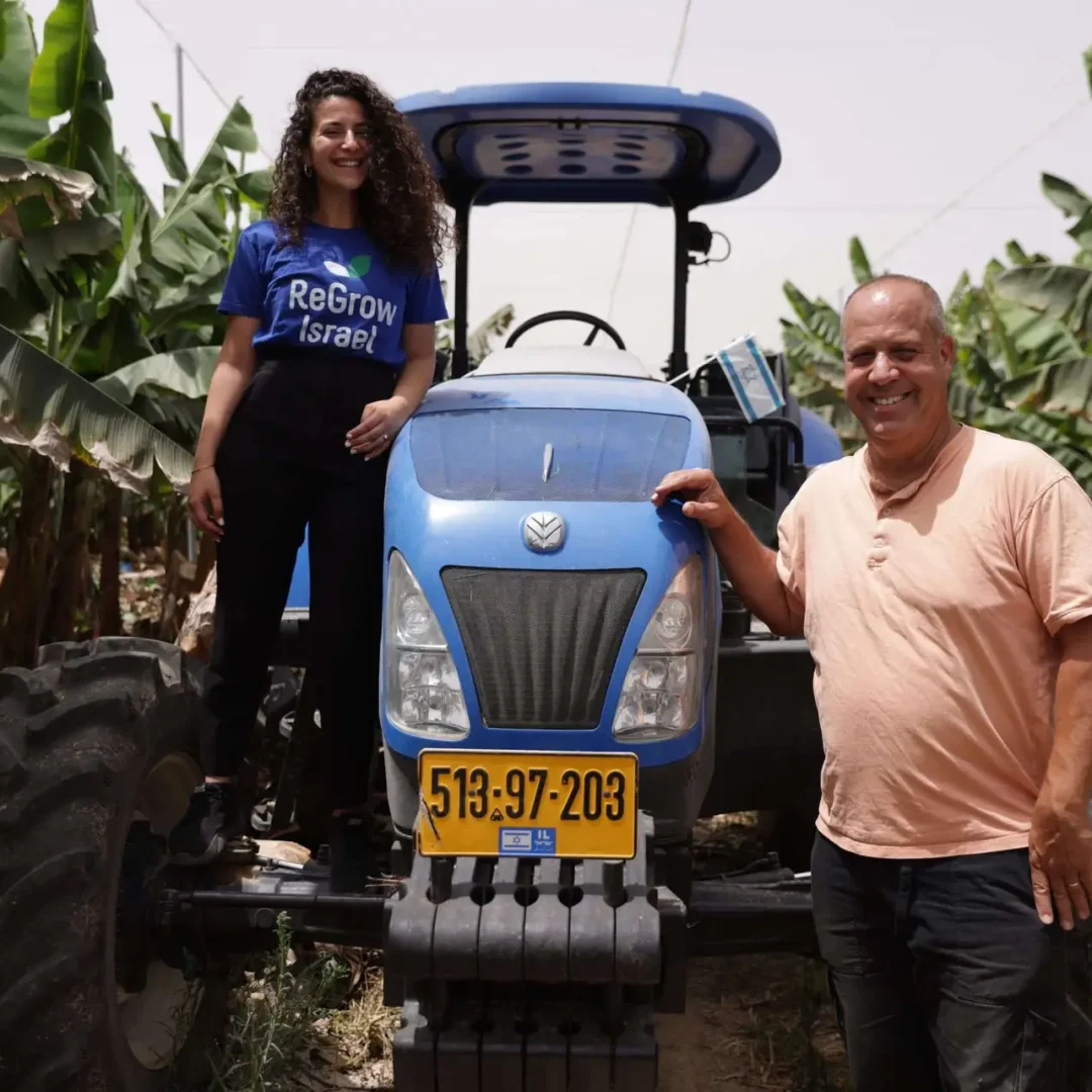 Man and Woman Smile with Tractor with Plants in BG