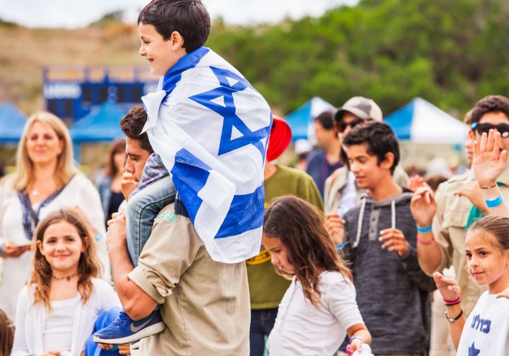 Scout Carries Boy Wrapped in Israeli Flag