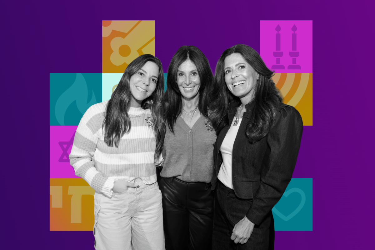 Three smiling women posing together in front of a colorful geometric background.