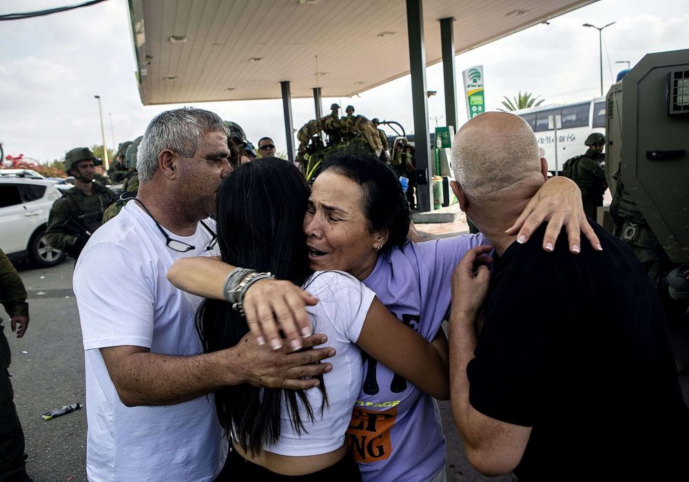 An israeli family embraces each other after being freed  by IDF special forces from one of the settlements that were under attack by Hamas terroists on October 7.